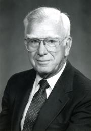 Headshot of Harry Hillaker wearing a suit and tie