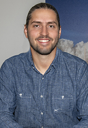 Headshot of Kiko Dontchev smiling wearing a blue collard shirt